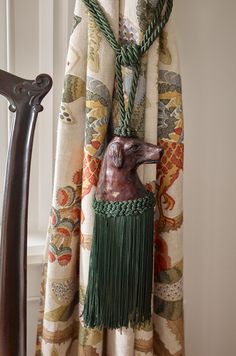 a curtain with a dog head hanging from it's side