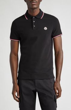 Classic tipping at the collar and cuffs enhances the sporty look of this cotton-piqué polo detailed with Moncler's signature cockerel logo at the chest. Button half-placket Rib collar Short sleeves with rib cuffs 100% cotton Dry clean or hand wash, dry flat Made in Turkey Men's Designer Clothing Designer Black Polo Shirt With Collared Neckline, Black Designer Polo Shirt With Collared Neckline, Designer Black Polo Shirt With Ribbed Collar, Designer Black Polo Shirt With Embroidered Logo, Classic Black Polo Shirt With Contrast Collar, Fitted Black Polo Shirt With Striped Collar, Black Polo Shirt With Contrast Trim And Short Sleeves, Black Short Sleeve Polo Shirt With Contrast Trim, Designer Black Polo Shirt For Work