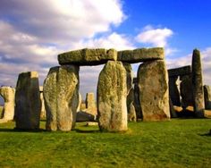 the stonehenge monument in england is surrounded by green grass and blue sky with clouds