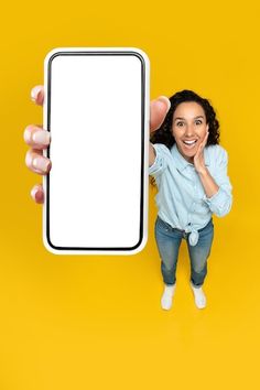 a woman holding up a tablet computer with a blank screen in front of her face