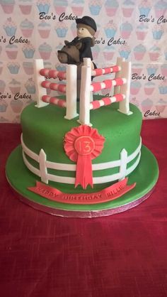 a birthday cake with a horse and fence on the top is for a child's first birthday