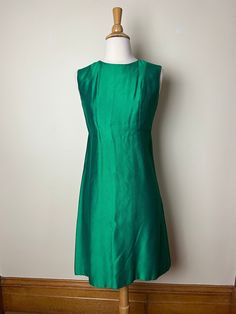 "Vintage 60s Saks Fifth Avenue Green cocktail dress. 1960s Saks vintage green version of a little black dress. Gorgeous cocktail dress, sleeveless, hits at knee, simple and elegant and ready for the holidays! Halfway seam under bust in front and back, zip and hook and eye closure in back. Bust area has extra lining, rest of dress has two layers of fabric- outer shell and inner layer, sewn together at hem. Hits at knee. Material not listed, but feels like a silk shantung, though possibly could be Green Cocktail Dress, Saks Fifth Avenue, Silk Dress, Dress Clothes For Women, Vintage Dresses, Little Black Dress, Cocktail Dress, Dress Outfits, Vintage Fashion