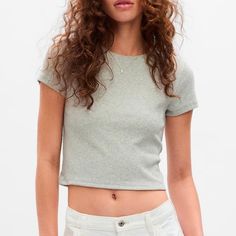 New With Tag Gap Cropped Rib T-Shirt Light Heather Grey S Fit & Sizing Straight, Cropped Silhouette With A Slim Fit. Hits At The Waist. Models Are 5’9.5”5’10” (175177 Cm) With 3234” (8186 Cm) Bust, 2426” (6166 Cm) Waist & 3538” & (8997 Cm) Hips Wearing Gap Size 4. Product Details Soft, Stretch, Cropped Ribbed Knit T-Shirt. Crewneck. Short Sleeves. #757765 Fabric & Care Cotton 94%, Spandex 6% Machine Wash. Imported. Trendy Stretch Tops By Gap, Trendy Stretch Tops From Gap, Gap Cropped Tops For Spring, Fitted Casual Crop Top By Gap, Fitted Gap Tops, Fitted Heather Grey Crew Neck Tops, Basic Stretch Gap T-shirt, Gap Tops For Spring, Fitted Gap Tops For Summer