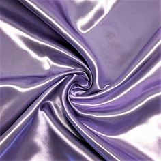 The bridal satin is a luxurious satin fabric. It is 60" wide, 160GSM, and 100% polyester. Known for its silky smooth touch and radiant colors, this high quality satin is ideal for: -glamorous gowns -bridal wear -bridesmaid dress -cocktail dresses -blouses and many other forms of apparel! The bridal satin has a sturdy body and a soft drape which makes it great for curtains, drapes, table sashes and other event decor. It is your go to fabric for a medium-heavy drape that shines and shimmers. Large Bulk Fabric, Bracelet Bag, Silver Cocktail Dress, Crystal Wedding Dress, Dresses By Color, Lavender Aesthetic, Dress Fabrics, Satin Pillow, Silver Cocktail