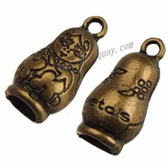 two antique brass bell charms with cats on them