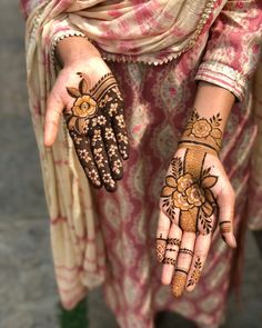 a woman's hands with hennap painted on them