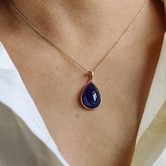 ITEM DESCRIPTION: >>The pendant is made from Solid 14K Yellow Gold. Gemstone used is absolutely natural and ethically sourced. >>Natural Tanzanite Cabochon in thick bezel setting is studded on it with utmost precision. >>This is a minimalist design and is absolutely hassle-free and everyday jewelry. Gem: Tanzanite Gem size: 13x18 mm & Pear Gem weight: 14.55 carats Gold purity: 14K (58.33% approx.) Gold weight: 0.65 grams Gross weight: 3.56 grams The Gold purity is guaranteed and it comes with au Gold Tanzanite Jewelry With Bezel Setting, Teardrop Tanzanite Jewelry In Yellow Gold, Elegant Gold Gemstones With Polished Finish, Pear-shaped Sapphire Gemstone Jewelry, Elegant Yellow Gold Pear-shaped Gemstones, Elegant Pear-shaped Yellow Gold Gemstones, Gold Tanzanite Teardrop Jewelry, Sapphire Pear-shaped Gemstone Jewelry, Gold Pear-shaped Jewelry With Bezel Setting