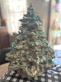 a small christmas tree sitting on top of a table