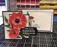 a card with some flowers on it sitting on a table next to other greeting cards