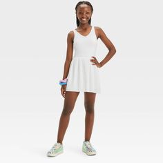 Why we're ALL IN: Solid-color sleeveless active dress with built-in shorts and a pleated skirt. Made from recycled polyester fabric with added spandex for flexible wear. Boasts moisture-wicking and quick-drying construction for comfort during any activity. The hidden pocket, built-in shorts, V-neckline and keyhole cut-out back complete the sporty design. All in Motion™: Inspiring the potential in every body. Summer School Mini Dress, Casual Summer School Dresses, Casual Mini Dress For School In Spring, Spring Skirted Tennis Dress For Sports, Spring Skirted Sporty Tennis Dress, Spring Sports Tennis Dress With Skirt, Stretch Skirted Tennis Dress For Spring, Sleeveless Summer School Dress, Casual Solid Mini Length Tennis Dress