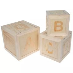 three wooden blocks with the letters abc and j on them, all in different sizes