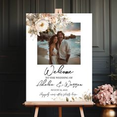 an easel with a photo and flowers on it