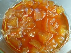 a bowl filled with oranges and ice on top of a table