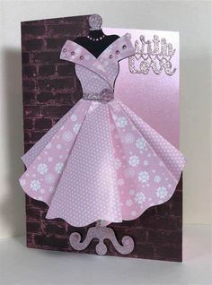 a card with a pink dress on it