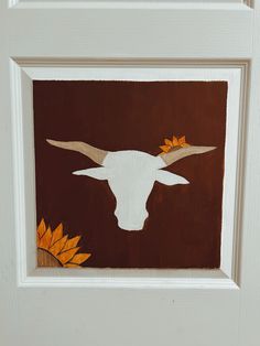 a painting of a longhorn with sunflowers on it