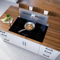 a skillet is sitting on top of a stove in the middle of a kitchen