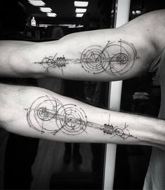 two men's arm tattoos with circles and lines on their arms in black ink