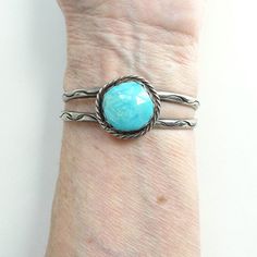 This is a Navajo Turquoise Cuff Bracelet Gorgeous Blue Stone Incised Designs Native American. This sterling silver (tested) cuff bracelet has a gorgeous bluish turquoise stone, stamp decoration, a pulled wire cuff, and plated terminals. There is tarnish/patina. The bracelet is not signed. The bracelet measures 5 1/8 inches around plus a 1 inch gap for a total of 6 1/8 inches. The width is 7/8 inch and the bracelet weighs 24.9 grams. The bracelet fits my 6 1/4 inch wrist. There is no flexibility Southwestern Style Turquoise Cuff Bracelet, Southwestern Style Round Turquoise Cuff Bracelet, Wire Cuff, Malachite Jewelry, Turquoise Bracelet Cuff, Navajo Turquoise, Selling Antiques, Turquoise Cuff, Vintage Navajo