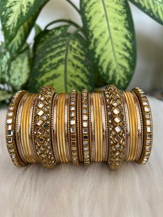 The perfect accessory for your special occasions, these  Golden Color Bangles feature Kundan and Stone detailing. Crafted with copper, these bangles are sure to add a touch of elegance and glamour to your look. Features: * Copper material *  kundan  detailing *   Golden Color * Size: 2.8,2.10 Elegant Rose Gold Copper Bangle, Party Jewelry In Gold-toned Copper, Gold Copper Bangle Jewelry, Elegant Gold-colored Copper Bracelets, Elegant Gold-colored Copper Bracelet, Traditional Gold-colored Copper Bangle, Golden Bangles Set, Golden Bangles, Bangles Set