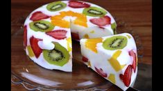 a cake with fruit on it sitting on top of a glass plate