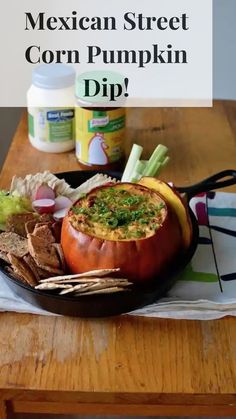 mexican street corn pumpkin dip in a cast iron skillet on a table with tortilla chips