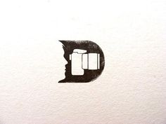 the letter c is made up of black and white paper with an image of a man's head