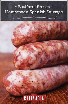 three sausages sitting on top of a wooden table