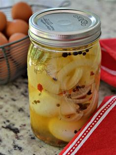 a glass jar filled with pickles and eggs