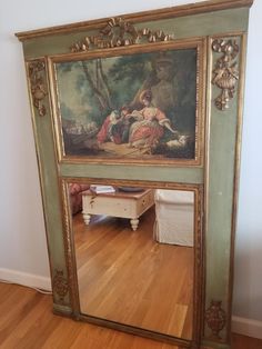 there is a large mirror on the floor in front of a wall with an old painting