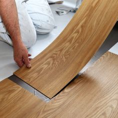 a man working on wood floors with the words effective solutions for all your flooring needs