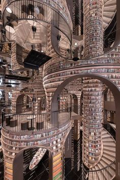 a spiral staircase made out of books is shown in this image, with multiple levels