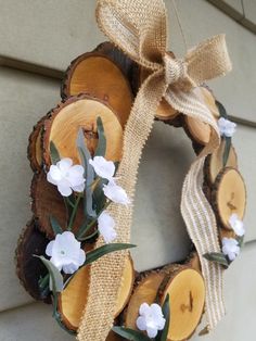 a wreath made out of wood with white flowers