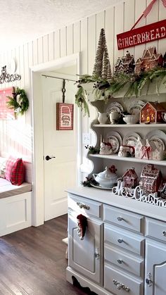 a white hutch filled with christmas decorations