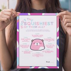 a woman holding up a poster with the words squishiest on it