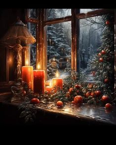 two candles are lit in front of a window with christmas decorations and fruit on the windowsill