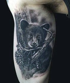 a black and white tattoo with a bear holding a branch in it's paws