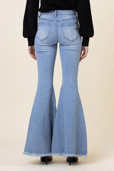 A pair of high-rise full-length flare jeans featuring faux front pockets and 2 Back patch pockets,zip-fly closure, and raw hem. Rise: 10.5" Inseam: 34" Model is 5'8" and wearing a size 3 Sweatshirt Jean Jacket, Women Cargo Pants, High Waisted Flare Jeans, Jumpsuits And Romper, High Waisted Flares, Night Out Dress, Jeans Online, Back Patch, High Jeans