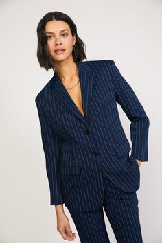 This navy blazer nods to classic menswear tailoring with a structured silhouette in delicate pinstripes. The single-breasted jacket features a smart cut and timeless details: notched lapels, flap pockets, and a vented back hem to ease the fit. •Padded shoulders •Notched lapels •Welt pocket at chest •Button closures at front DIMENSIONS •Standard: 18" Length Item number 2220097 100% Polyester Hand Wash Cold Indigo Suits Women, Blue Suit Women, Pinstripe Blazer, Elegant Blazers, Single Breasted Blazer, Blazer Beige, Corduroy Blazer, Blazer Designs, Navy Blazer