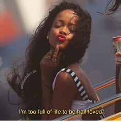 a woman with long hair holding a drink and talking on the phone