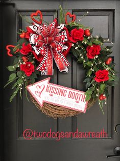 a valentine's day wreath with red roses and candy canes on the front door