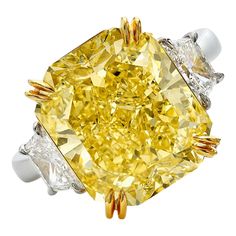 a fancy yellow diamond ring with three diamonds