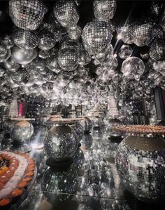 many shiny balls are hanging from the ceiling