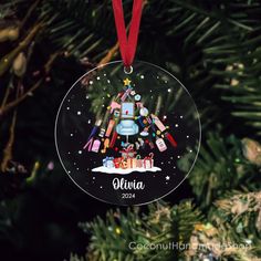 an ornament hanging from a christmas tree with presents on it and the name victoria