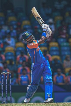 a man swinging a cricket bat on top of a field