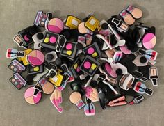 a pile of barbie doll hair and makeup accessories sitting on the floor next to each other