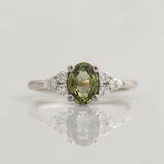 an oval green and white diamond ring