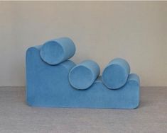 a blue couch sitting on top of a gray floor