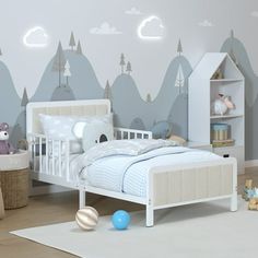 a child's bedroom with mountains and clouds painted on the wall behind the bed