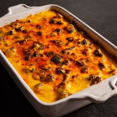 a casserole dish with meat and cheese in it sitting on a table top