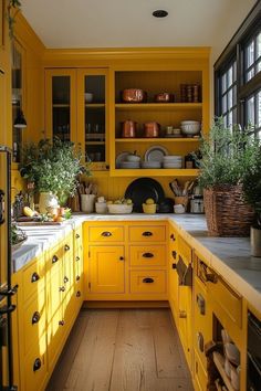 a kitchen with yellow cupboards and wooden floors is pictured in this image from the inside